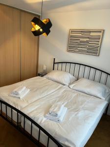 a bedroom with a bed with two towels on it at In City by IQ Apartments in Prešov