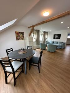 a living room with a table and chairs and a couch at Apartmány Tachov in Tachov