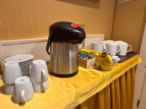 a coffee pot sitting on a table with cups at Hotel Corte Contarina in Venice