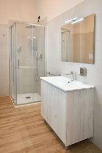 a white bathroom with a sink and a shower at Palazzo Cavalieri business&relax 10Galvano in Castiglione delle Stiviere +41 photos