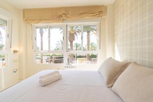 a white bed in a room with a window at Paraíso Frente al Mar con Piscina - By Aloha Palma in Águilas +25 photos