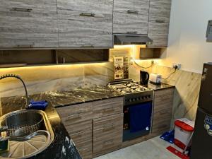 a kitchen with a stove and a sink at Modern Stand alone estate house in Mombasa +15 photos