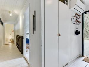 a hallway of a house with white walls at Holiday Home Judyta - 1km from the sea by Interhome in Fanø +21 photos