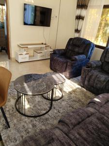 a living room with a couch and a coffee table at Modern Stand alone estate house in Mombasa