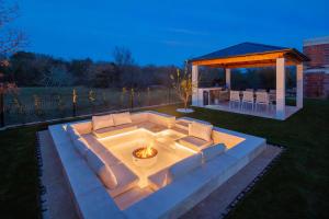a fire pit in a yard with a gazebo at Villa Neoma in Linardići