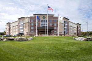 a large building with two flags in front of it at Homewood Suites by Hilton Pittsburgh-Southpointe in Canonsburg