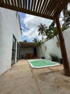 a swimming pool in the courtyard of a house at Casa Branca Mediterrânea in Barra Grande