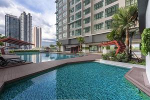 a large swimming pool in front of a building at Group-Friendly Stay in Putrajaya & IOI City Mall in Putrajaya