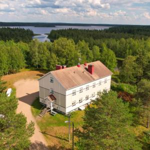 an aerial view of a large white house with trees at Staycation Törrö Terveyssisar as 1 in Pudasjärvi