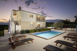 a house with a swimming pool in front of it at 4 bedroom villa Renata near Porec in Kaštelir