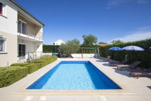 a swimming pool in the backyard of a house at 4 bedroom villa Renata near Porec in Kaštelir