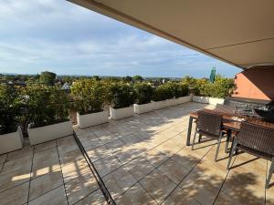 a patio with a table and chairs on a roof at Penthouse mit Whirlpool, Traumblick und großer Dachterrasse in Bad Salzuflen