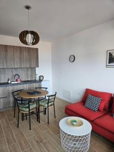 a living room with a red couch and a table at Luxury Apartments Danube in Golubac