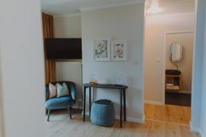 a room with a table and a chair and a mirror at Haggn&Co in Neukirchen