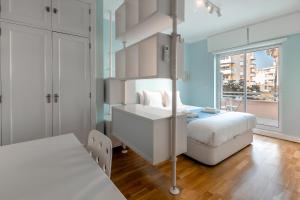 a white bedroom with a bed and a window at Lux Apt in Priv Condo with Pool, near Beach, Parking & Easy Access to Lisbon in Parede +93 photos