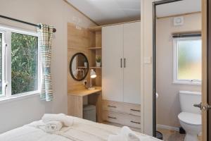 West DownにあるBeachy Lodge with Deck & Parking nr Ilfracombeの小さなバスルーム(ベッド1台、トイレ付) +13枚の写真