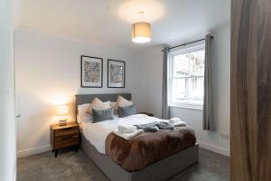 a bedroom with a large bed and a window at Lovely 1 Bed Harbour-side Apartment - Sea Views in Whitehaven