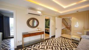 a living room with a sink and a staircase at Villa Paraiso by DanCenter | 4BHK Pvt Pool | Arpora in Goa