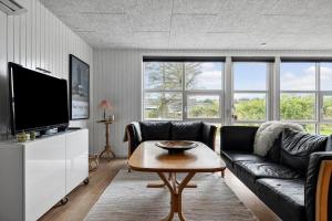 a living room with a couch and a table at LK2185-Lokken-Marthinesvej-17 in Grønhøj