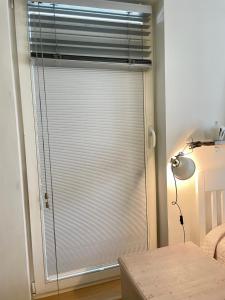 a window with blinds in a room with a table at Bright Home in Tallinn