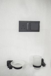 a white toilet with a plate on a wall at Sanasa Villa Weligama in Weligama +10 photos