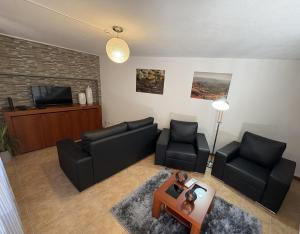 a living room with two couches and a tv at Recanto do Açor in Vide