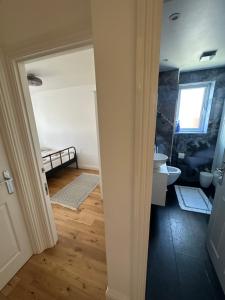 a bathroom with a sink and a toilet in a room at House in Watford +1 photo