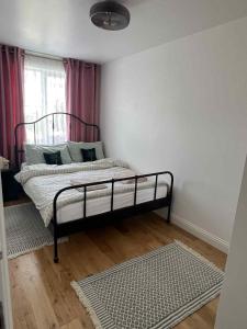 a bedroom with a bed in the corner of a room at House in Watford