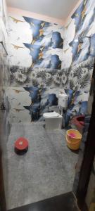 ein Bad mit einem WC und einer blau-weißen Wand in der Unterkunft Mountain View Farmstay in Matkuli