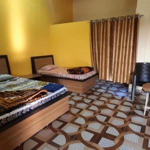 Zimmer mit 2 Betten und einer Katze auf dem Boden in der Unterkunft Mountain View Farmstay in Matkuli