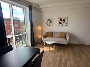a living room with a couch and a table at 37-2-7 City Apartment Dæmningen Vejle in Vejle