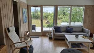 a living room with a couch and a table at FJ2402-Skibby-Lindevaenget-50 in Rønø