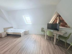 a room with a desk with a computer and a bed at Tercia Kópháza Panzió B in Kópháza