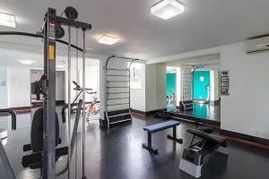 a room with a gym with a mirror at Loft Centro Oktoberfest - Blumenau in Blumenau