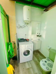 a bathroom with a washing machine and a toilet at Vega Maspalomas in San Bartolomé de Tirajana