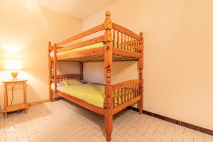 a bedroom with two bunk beds and a lamp at Résidence Arnaud Nicole - Appartement très spacieux au coeur du village MAE-0723 in Aussois
