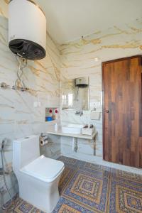 a bathroom with a toilet and a sink at Badakshan Bliss in Srinagar +19 photos