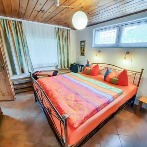 a bedroom with a large bed with colorful pillows at Bungalow 1 in Quetzin +14 photos
