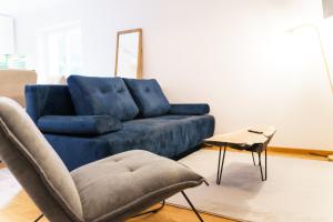a blue couch and a chair in a living room at Castelului Boutique-Old Town-Free Private Parking in Braşov +27 photos