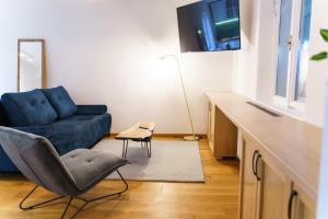 un salon avec un canapé bleu et une chaise dans l'établissement Castelului Boutique-Old Town-Free Private Parking, à Braşov