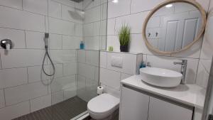 Un baño con inodoro, lavabo y espejo. en Benguella Breeze, en Swakopmund 11 fotos más