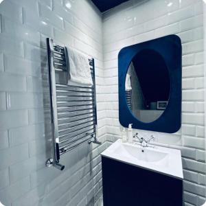 a white bathroom with a sink and a mirror at Lodge - Sleeps 18 pet friendly & free parking in Ravensworth +31 photos