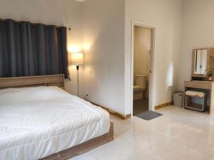 a bedroom with a bed and a bathroom at Minimal house in Doi Saket +6 photos