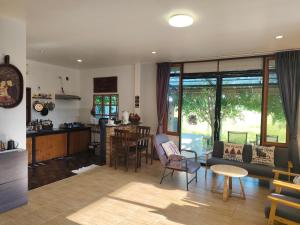 a living room with a couch and a table at Minimal house in Doi Saket