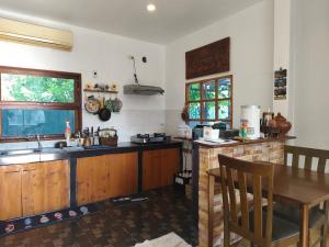 a kitchen with a sink and a table with a tableablish at Minimal house in Doi Saket