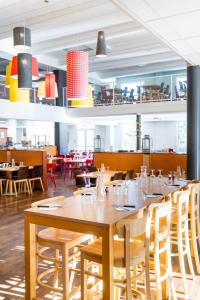 a large dining room with tables and chairs at Villages Clubs du Soleil - MONTGENEVRE in Montgenèvre