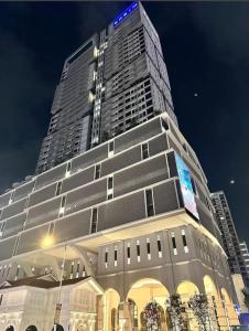 a tall building with a sign on top of it at 22 Macalisterz 2025 Georgetown Premium 顶楼无边泳池 in George Town +18 photos