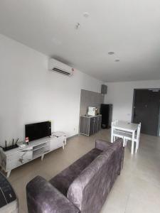 a living room with a couch and a table at 22 Macalisterz 2025 Georgetown Premium 顶楼无边泳池 in George Town