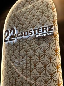 a close up of a book with the words easten at 22 Macalisterz 2025 Georgetown Premium 顶楼无边泳池 in George Town