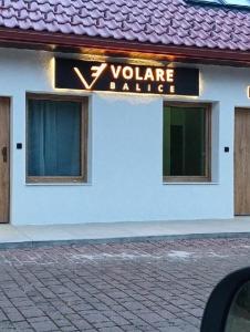 a building with a sign that reads y volume dance at Volare Balice in Cholerzyn